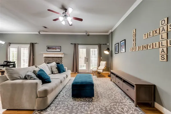 a living room with furniture ceiling fan and a rug