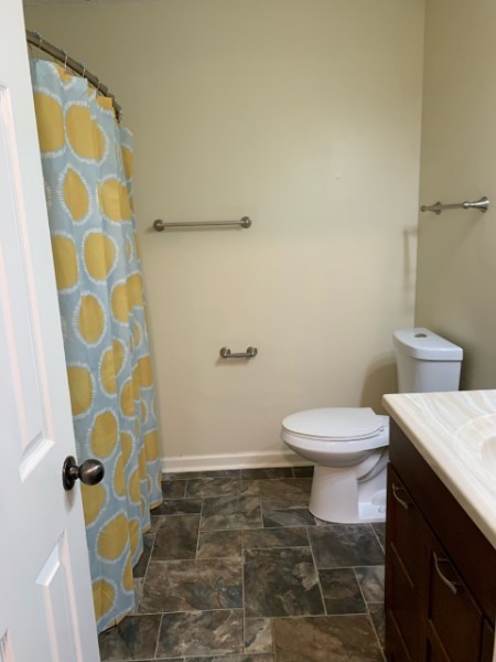 1314 Quail Valley Road Nashville, TN 37214 - Photo 3 of 6 a white toilet sitting next to a shower curtain