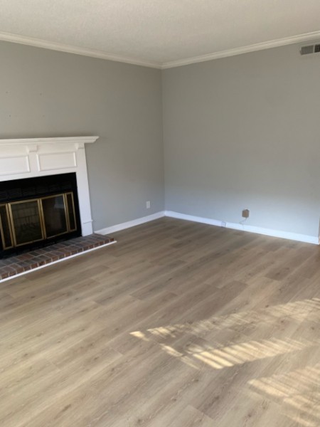 1314 Quail Valley Road Nashville, TN 37214 - Photo 6 of 6 a view of an empty room with wooden floor and a fireplace