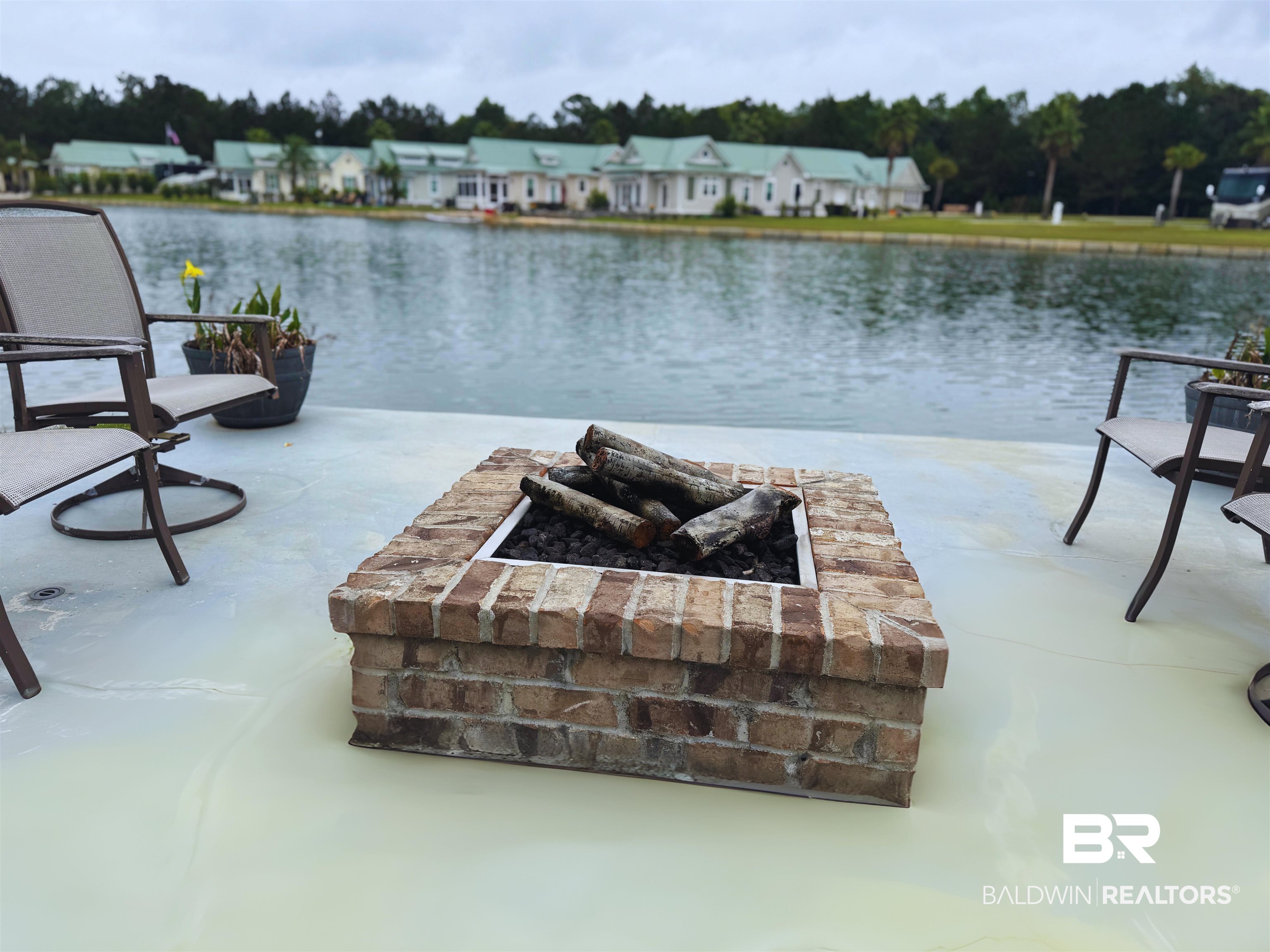 11996 Raptor Court Elberta, AL 36530 - Photo 12 of 45 View of patio with an outdoor fire pit and a water view