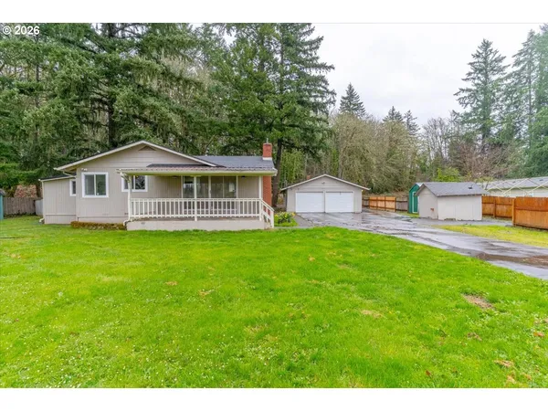 a view of a house with a backyard and a patio
