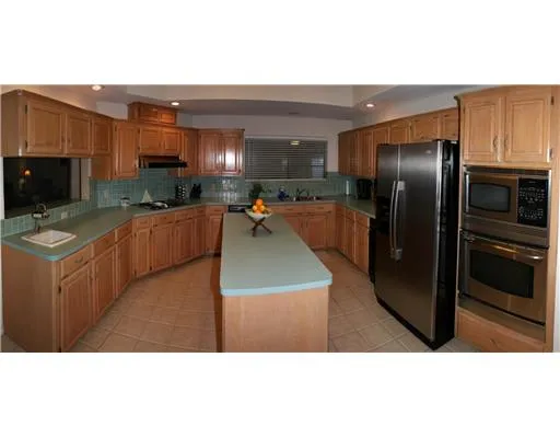 a kitchen with stainless steel appliances granite countertop a refrigerator a oven a sink and dishwasher