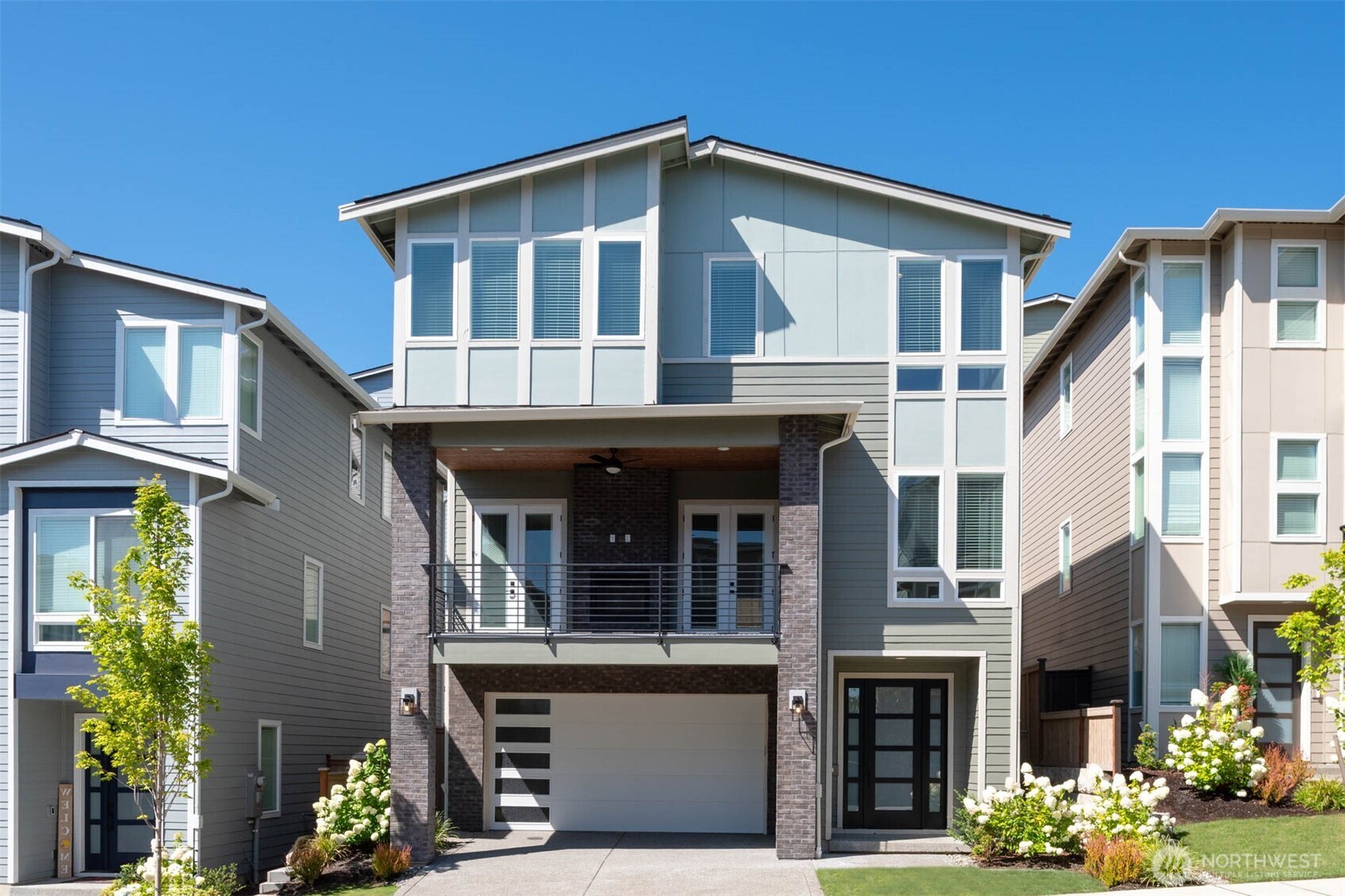 a front view of a house with a garden