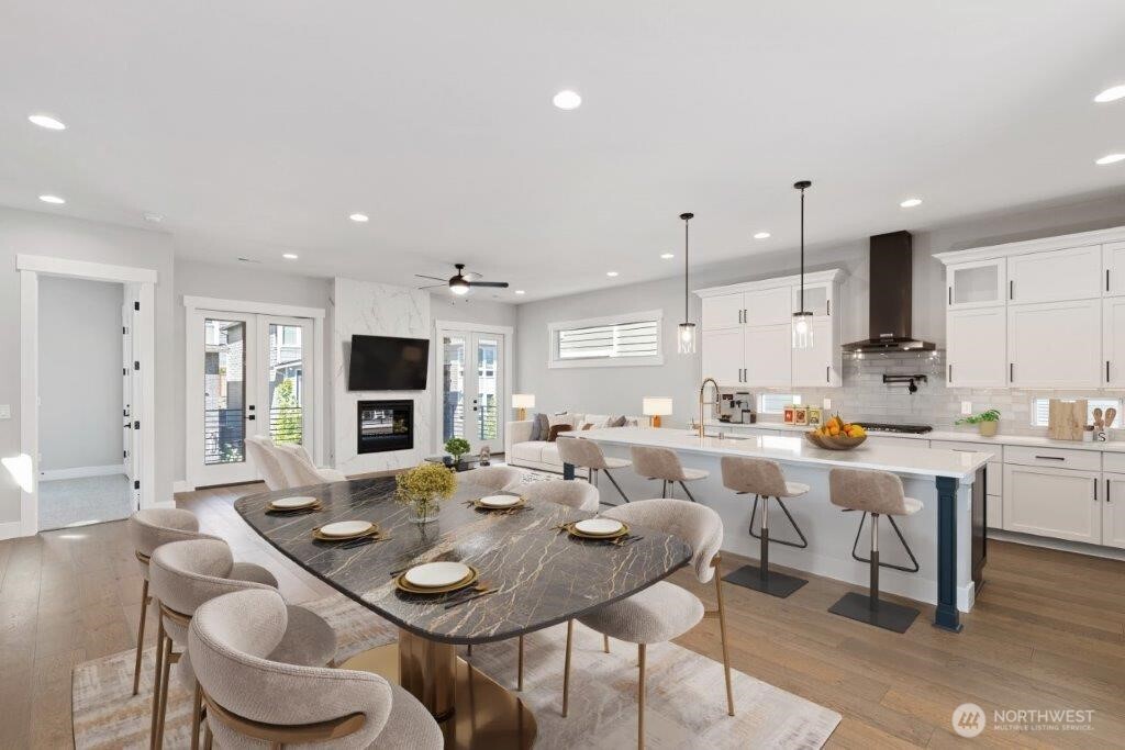 7573 South 130th Place Seattle, WA 98178 - Photo 4 of 10 a open dining room with furniture a large window and kitchen view