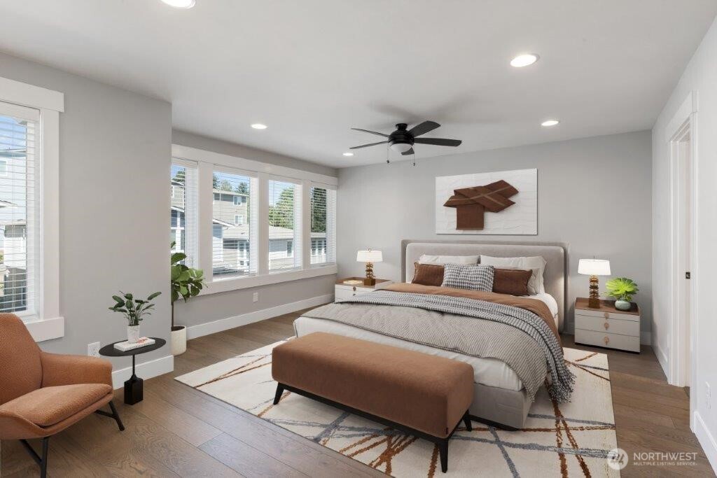 7573 South 130th Place Seattle, WA 98178 - Photo 8 of 10 a spacious bedroom with a bed a couch and a potted plant