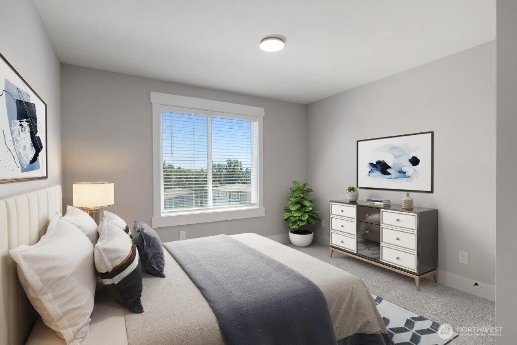 7573 South 130th Place Seattle, WA 98178 - Photo 10 of 10 a bedroom with a bed and a painting on the wall