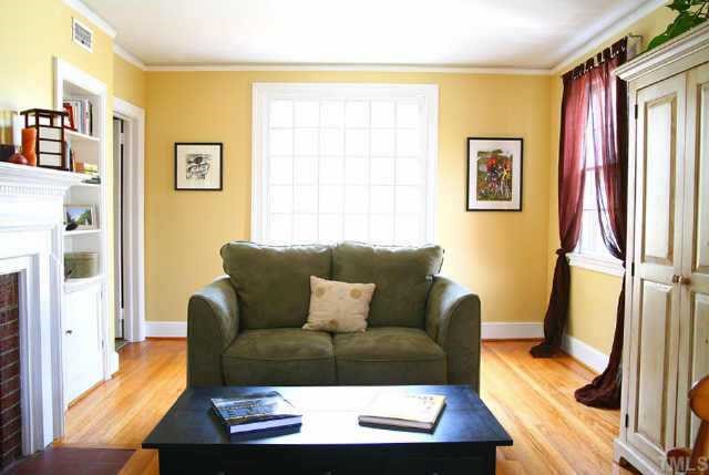 1515 Edgevale Road Durham, NC 27701 - Photo 3 of 10 The 21 ft. living room features oak floors, fireplace, picture molding, and a huge 42-light glazed rear window.