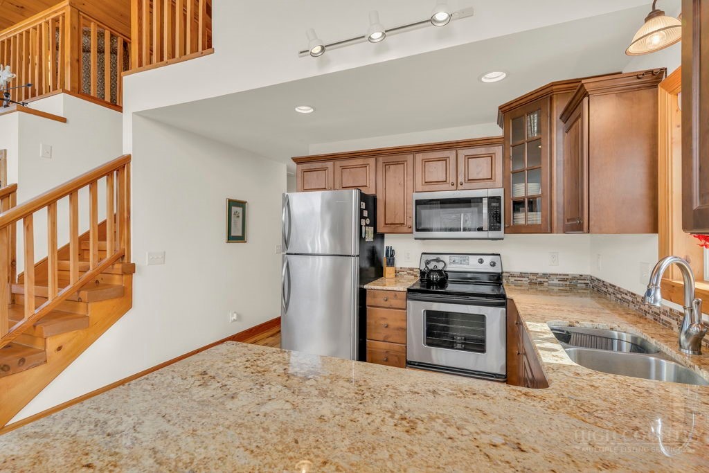 126 Knob Road Blowing Rock, NC 28605 - Photo 14 of 50 a kitchen with stainless steel appliances granite countertop a refrigerator a stove top oven a sink and dishwasher