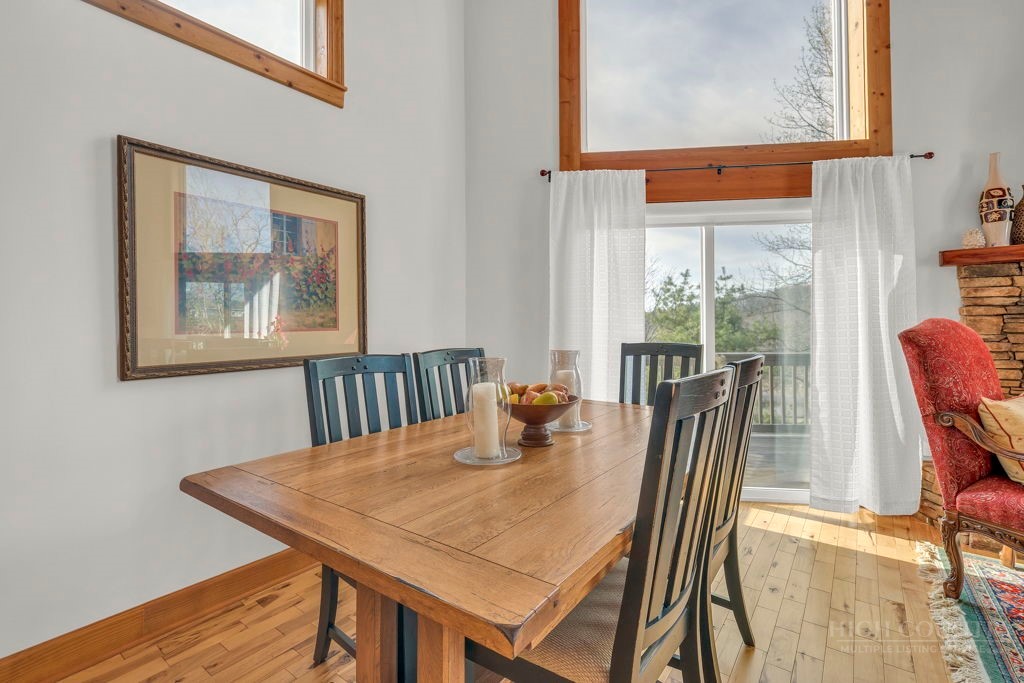 126 Knob Road Blowing Rock, NC 28605 - Photo 16 of 50 a view of a dining room with furniture and wooden floor