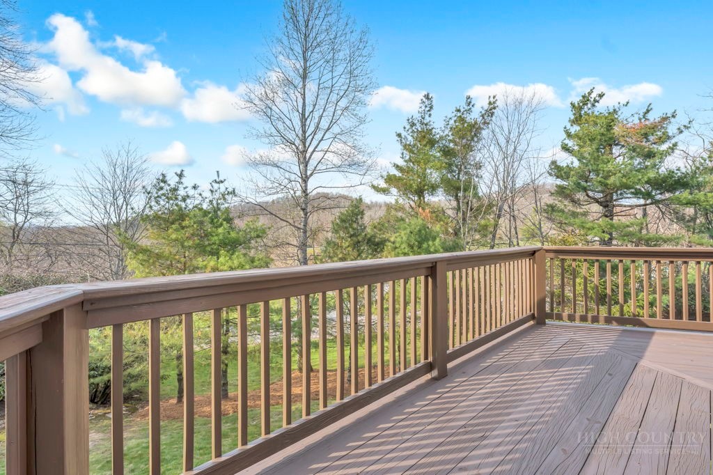 126 Knob Road Blowing Rock, NC 28605 - Photo 17 of 50 a balcony with wooden floor and fence