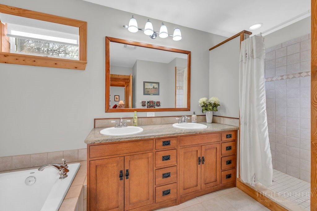 126 Knob Road Blowing Rock, NC 28605 - Photo 23 of 50 a bathroom with a double vanity sink and a mirror