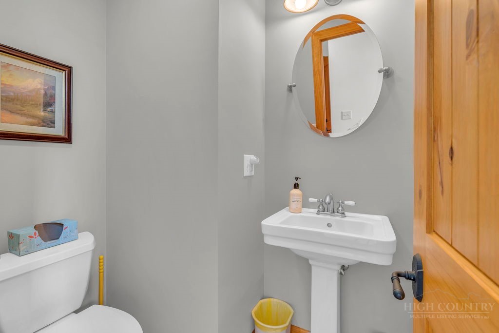 126 Knob Road Blowing Rock, NC 28605 - Photo 27 of 50 a bathroom with a sink mirror and toilet