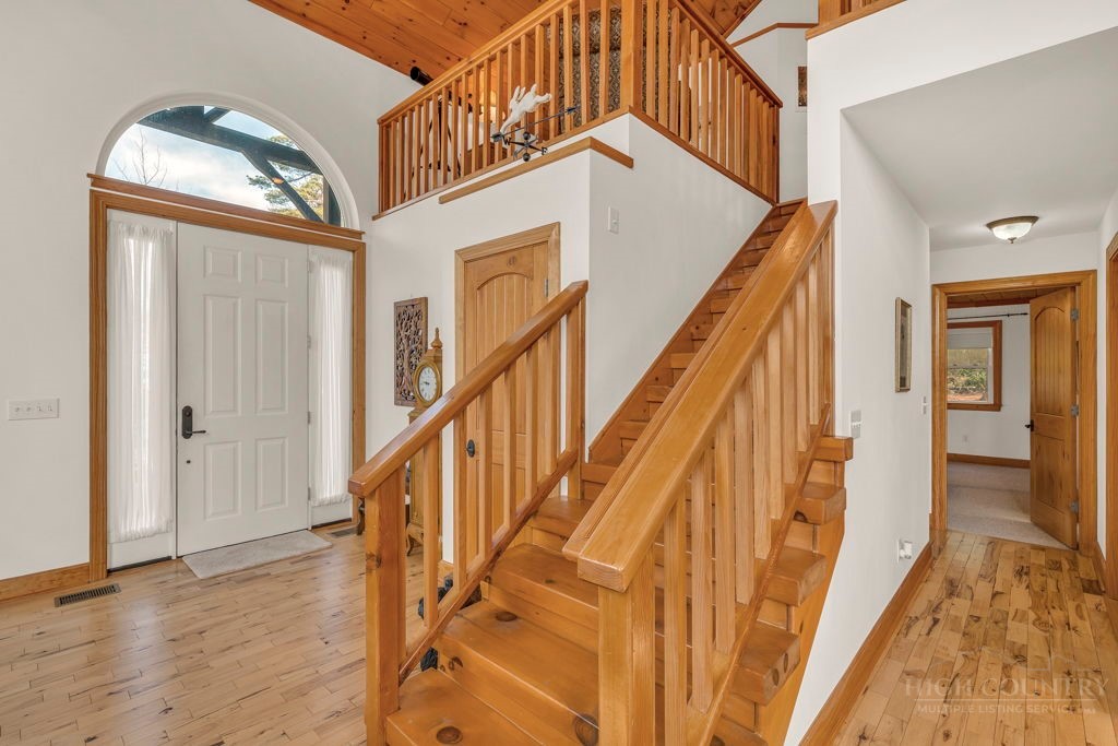 126 Knob Road Blowing Rock, NC 28605 - Photo 28 of 50 a view of staircase with lots of frames on wall and wooden floor