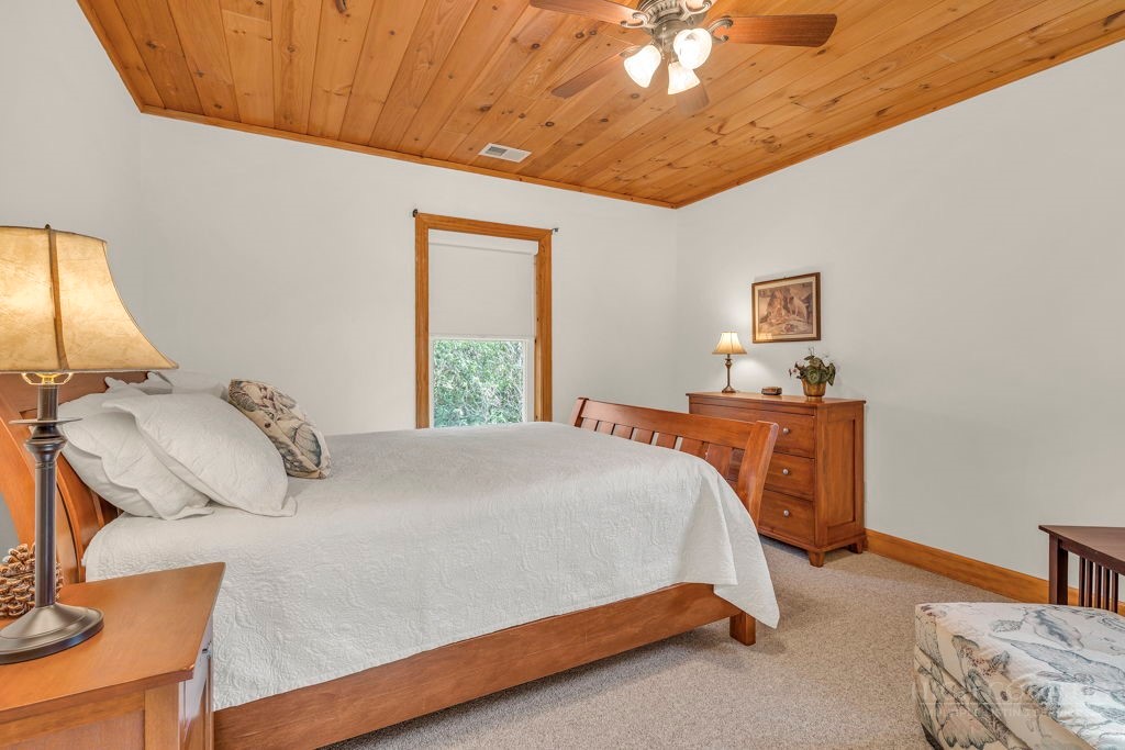 126 Knob Road Blowing Rock, NC 28605 - Photo 36 of 50 a bedroom with a bed and a chandelier