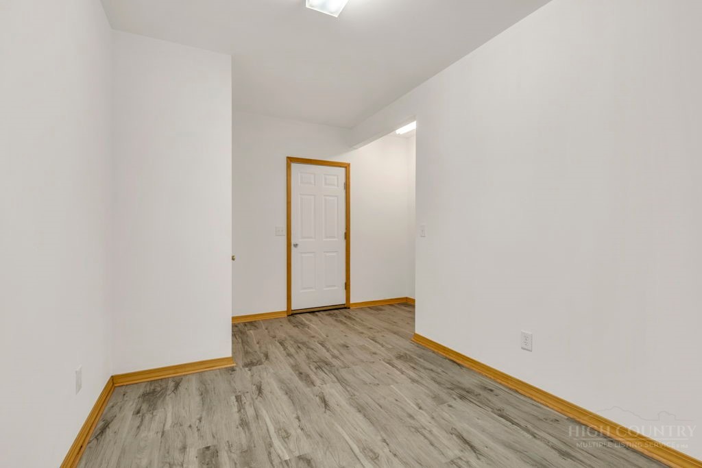 126 Knob Road Blowing Rock, NC 28605 - Photo 43 of 50 a view of an empty room with wooden floor