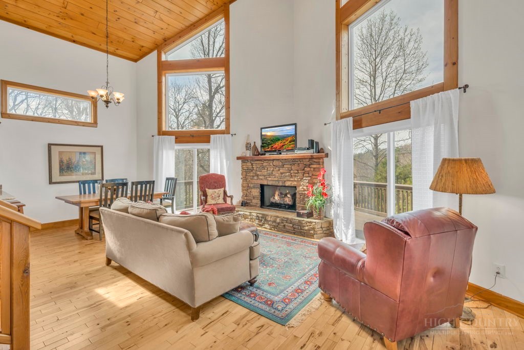 126 Knob Road Blowing Rock, NC 28605 - Photo 8 of 50 a living room with furniture a large window and a fireplace
