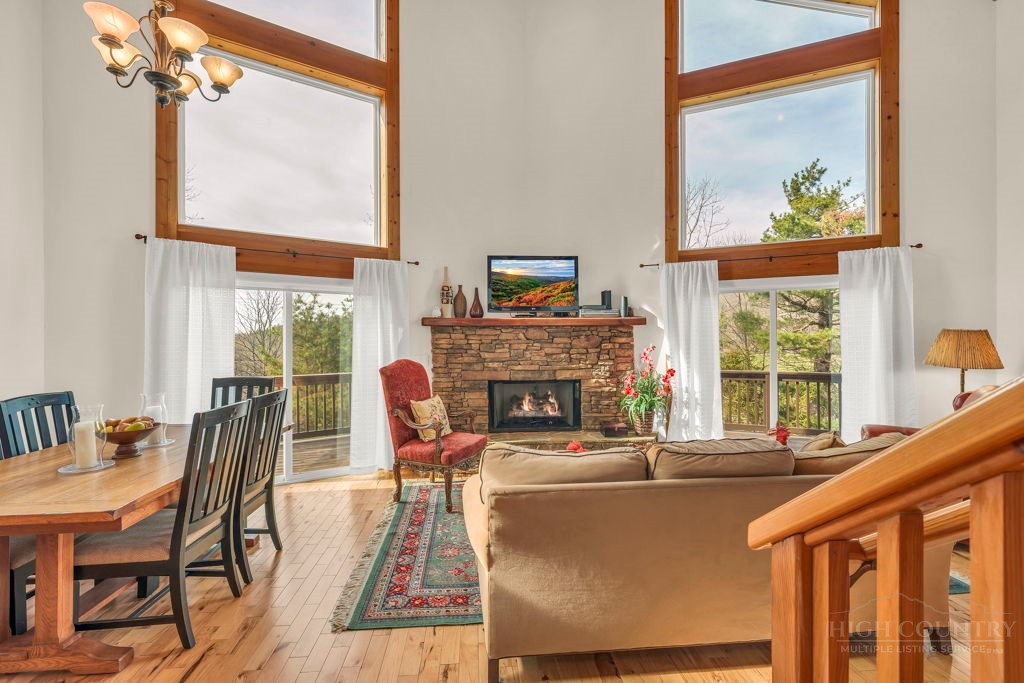 126 Knob Road Blowing Rock, NC 28605 - Photo 9 of 50 a living room with furniture a fireplace and a large window