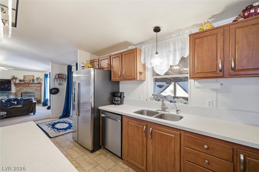 2380 West Simkins Road Pahrump, NV 89060 - Photo 16 of 38 Rich wood cabinetry and crisp countertops define this open-concept culinary workspace.