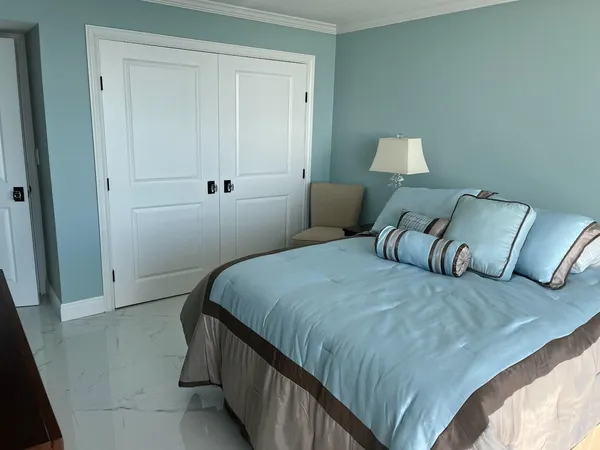 a bedroom with a bed and with furniture