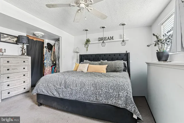 a bedroom with a bed and ceiling fan