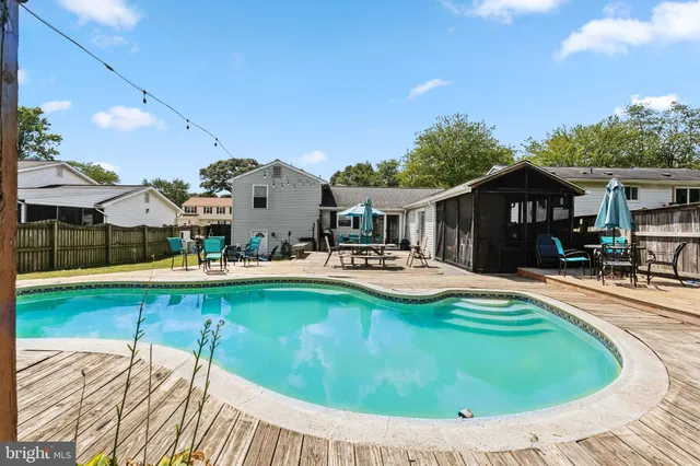 a swimming pool with outdoor seating and yard