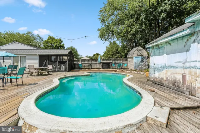 a swimming pool with outdoor seating and yard