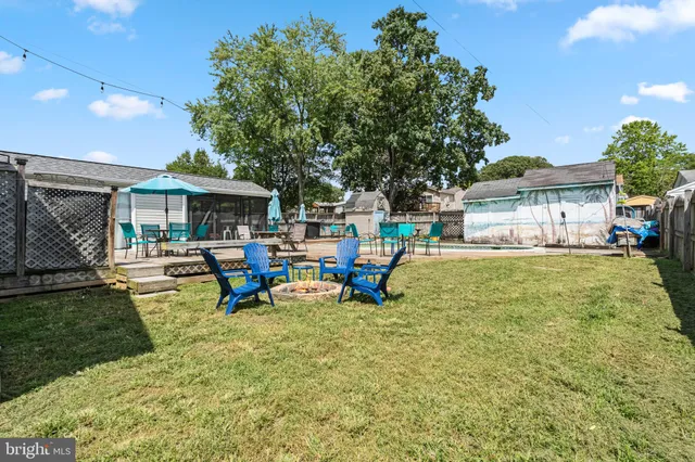 a view of a house with swimming pool and sitting area