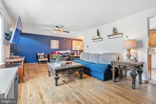 a living room with furniture and a wooden floor