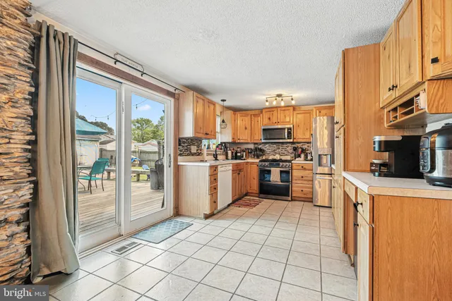a kitchen with stainless steel appliances a refrigerator and a stove top oven