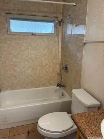 a bathroom with a toilet and a bath tub