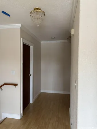 a view of an empty room with closet and a ceiling fan