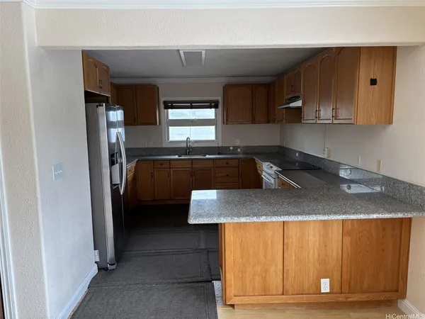 a kitchen with a sink cabinets and window