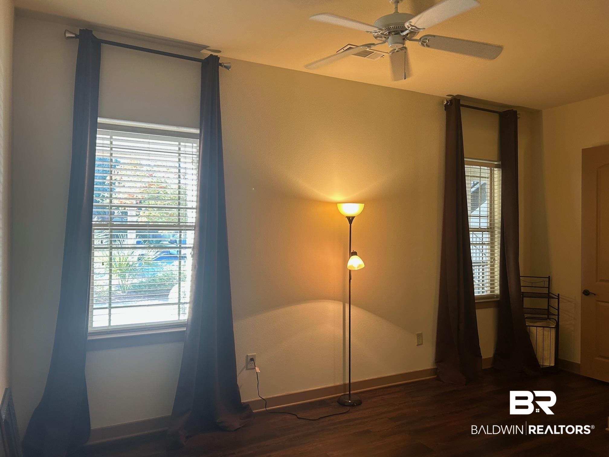 1430 Regency Road, Unit J102 Gulf Shores, AL 36542 - Photo 2 of 11 Unfurnished bedroom featuring ceiling fan and dark wood-type flooring