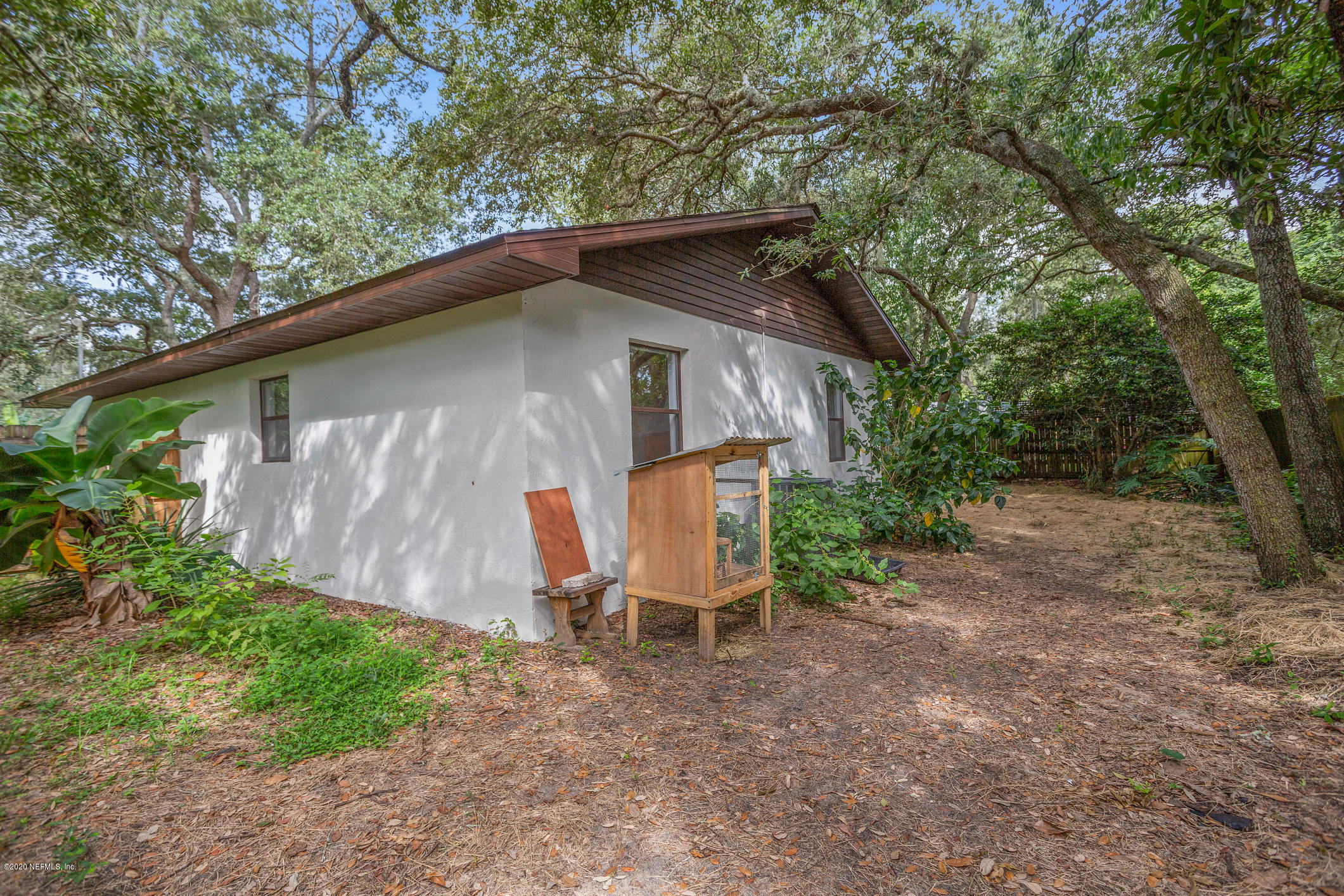 239 Bonita Road St. Augustine, FL 32086 - Photo 31 of 36 a backyard of a house with wooden deck and outdoor seating