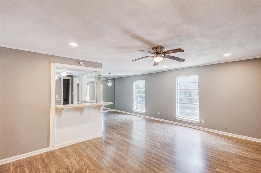 5057 Ridglea Lane, Unit 1111 Fort Worth, TX 76116 - Photo 3 of 7 a view of an empty room with window and wooden floor