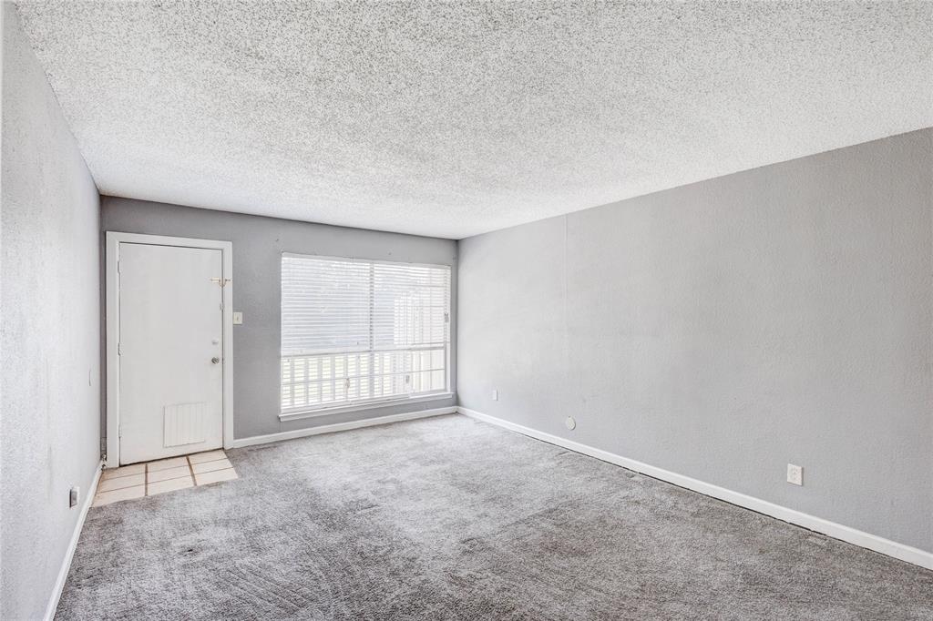 5057 Ridglea Lane, Unit 1111 Fort Worth, TX 76116 - Photo 5 of 7 an empty room with windows