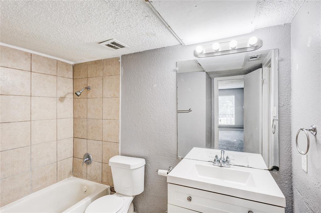 5057 Ridglea Lane, Unit 1111 Fort Worth, TX 76116 - Photo 6 of 7 a bathroom with a sink toilet and shower