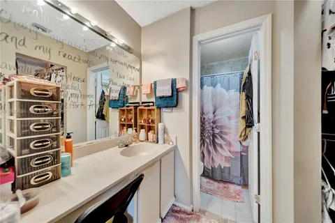 a view of a bathroom with a sink and mirror