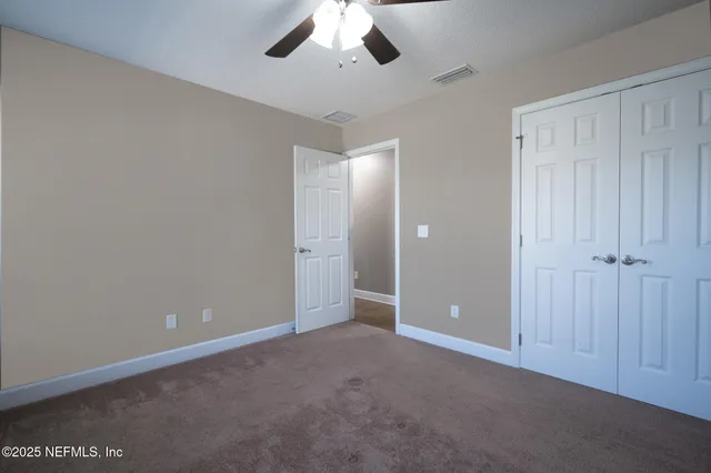 an empty room with a empty space and a ceiling fan
