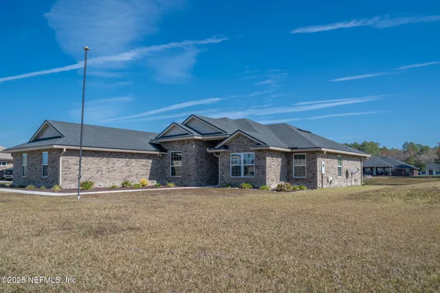a front view of a house with a garden