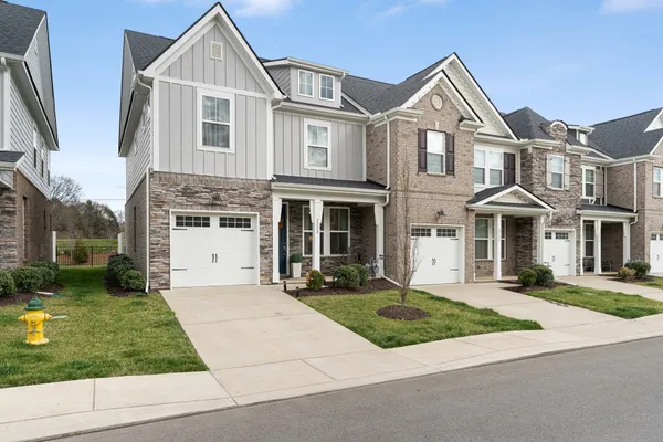 a front view of a house with a yard