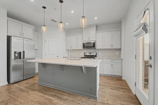 a kitchen with a sink stove and microwave