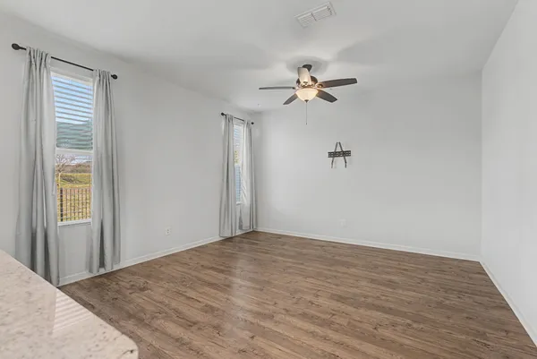 a large kitchen with a refrigerator and window