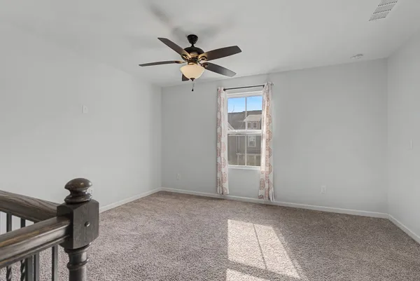 a bedroom with a bed and ceiling fan