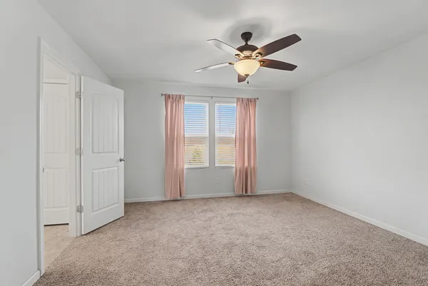 a bedroom with a large bed and a flat screen tv