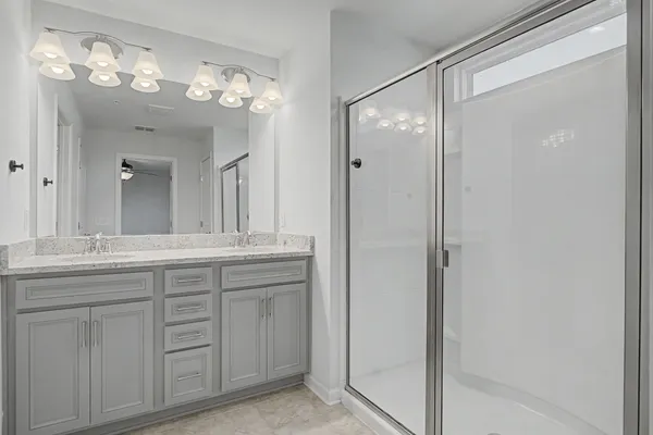 a bedroom with a bed and a potted plant