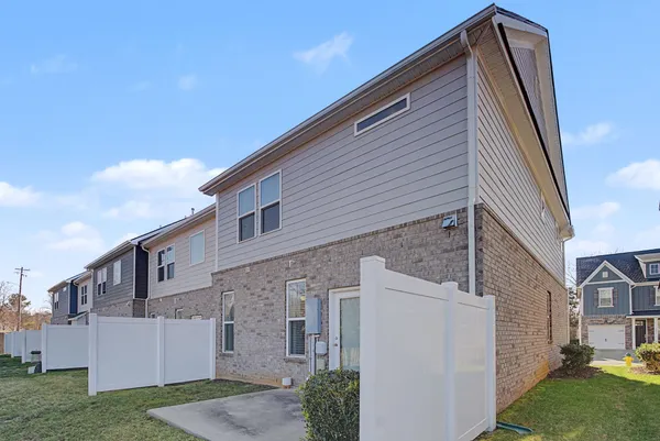 a view of a patio with table and chairs and potted plants