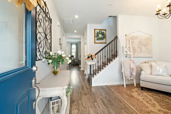 a view of a hallway with wooden floor and entryway