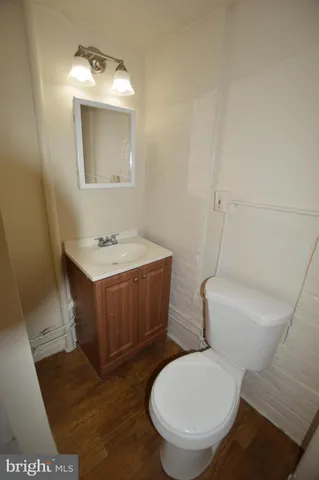 a bathroom with a toilet a sink and mirror