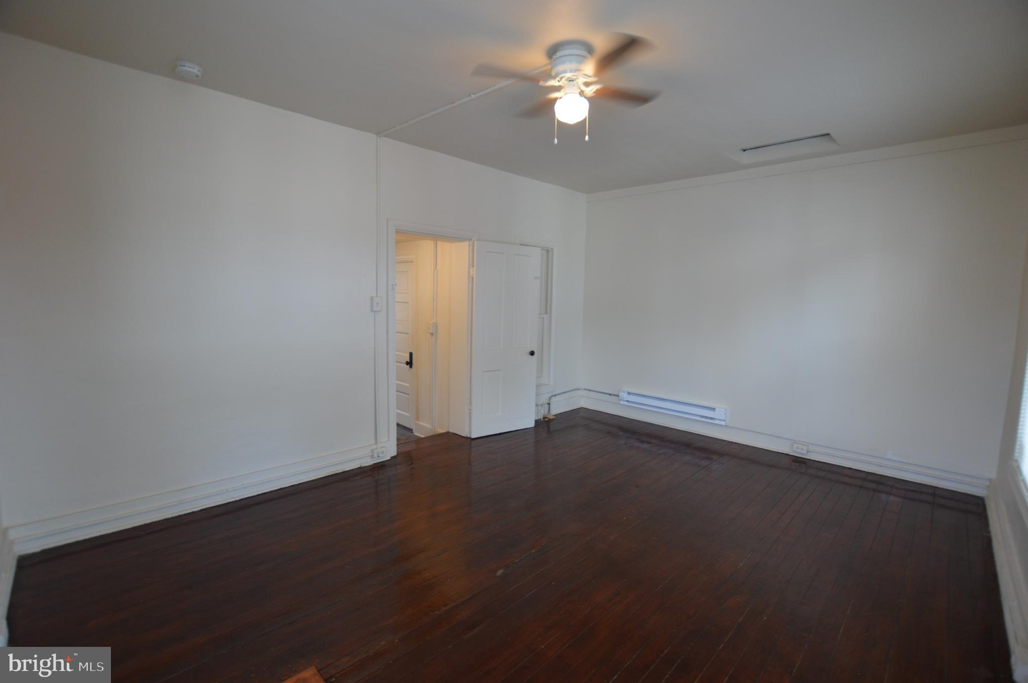 482 West South Street Frederick, MD 21701 - Photo 7 of 14 an empty room with a window and a ceiling fan